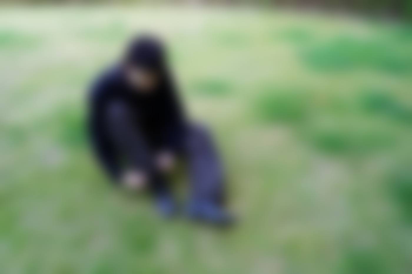Seated on grass